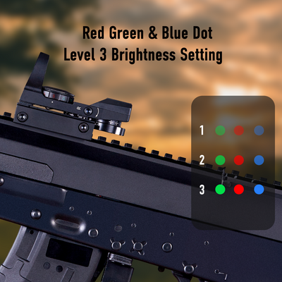 Rifle scope with red, green, and blue dot indicators on a blurred sunset background