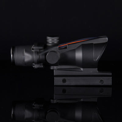 Black rifle scope with red dot on a black background